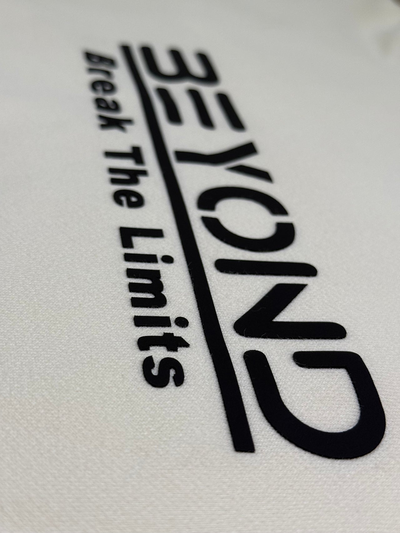 Beyond Elite Hoodie Apricot - Close-up of Break The Limits logo