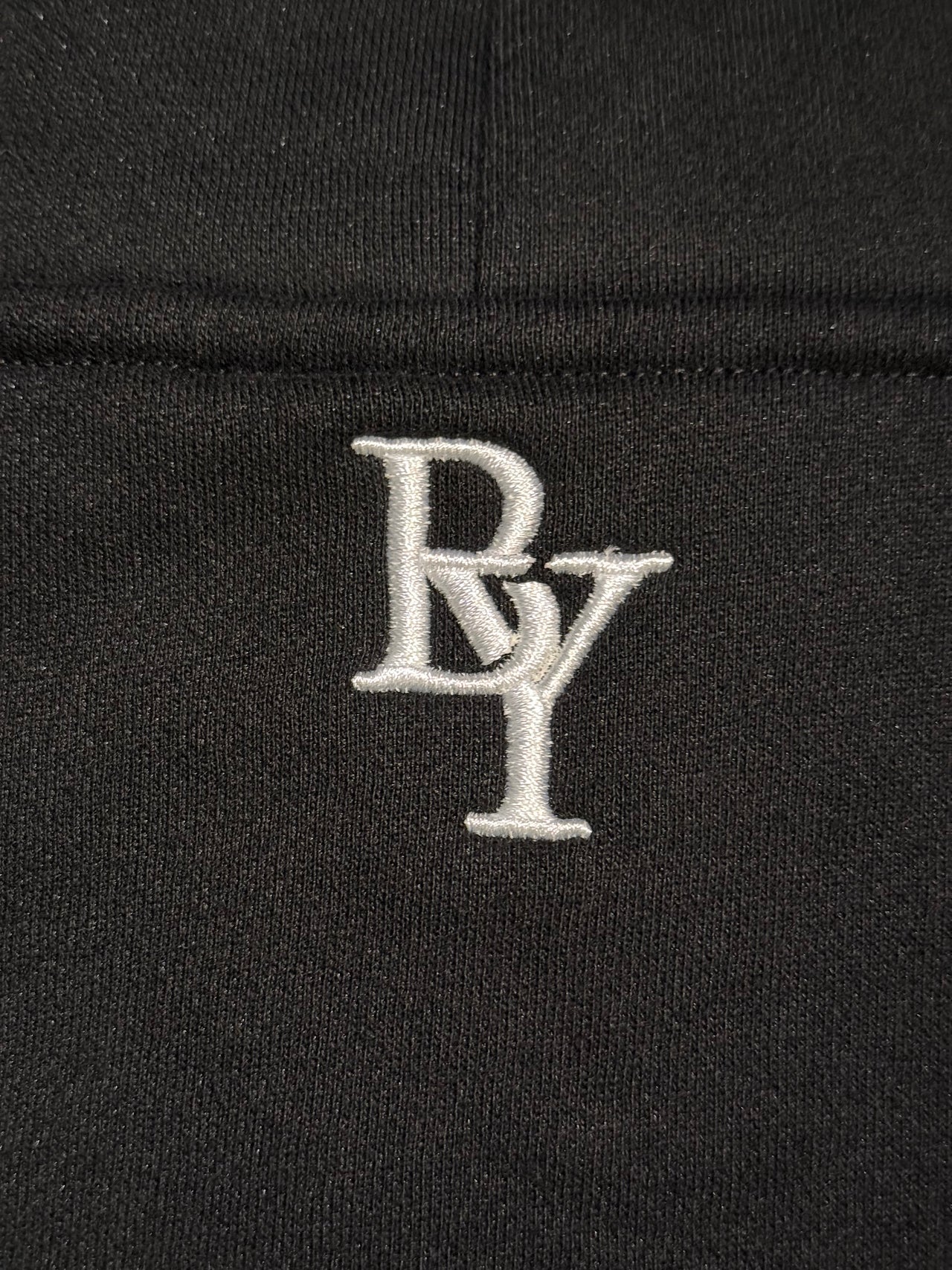 Elite Hoodie Stealth Black - Close-up of Logo