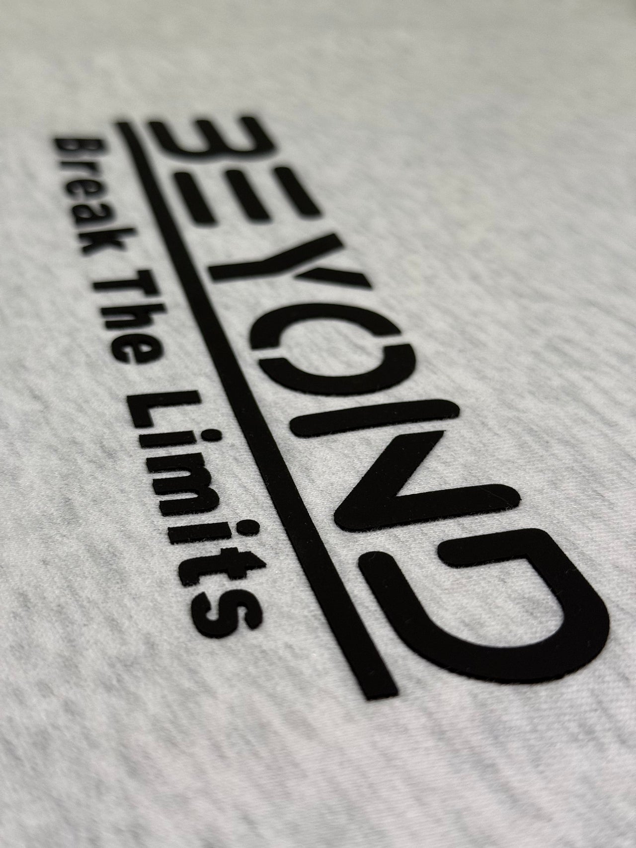 Beyond Elite Hoodie Storm Grey - Close-up of Beyond logo